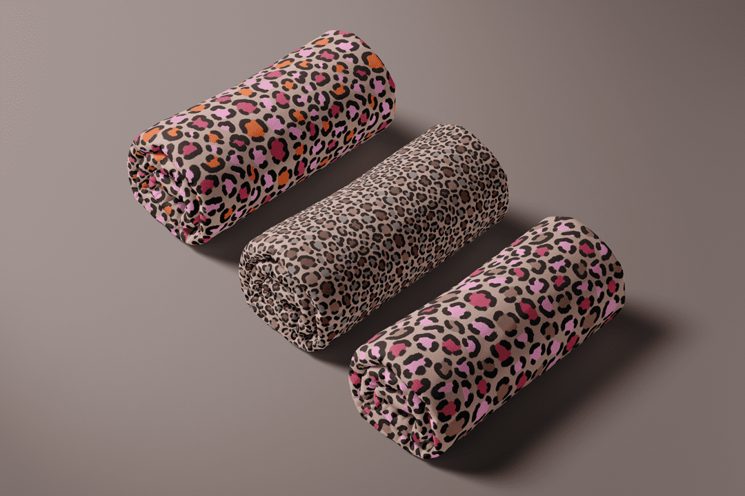 Leopard print fabric rolls in blush, coral, taupe, and black from Blush Safari for children’s fabric