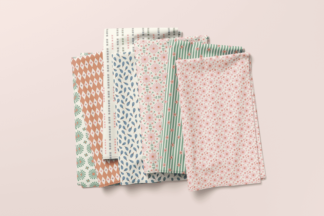 Mediterranean Bloom folded fabrics showing coordinated florals, stripes, leaves, and geometric prints.