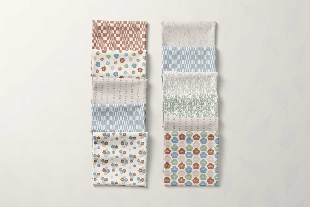 Fabric stash mockup from the Seigaiha Bloom collection with florals, waves, dots, and geometric prints by Studio Meggi.